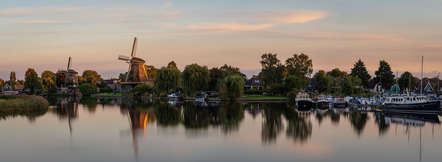 Panorama of Weesp, view of the historical windmills along the river Vecht in the evening