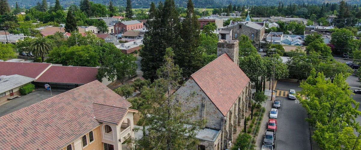 Aerial view of St. Helena Roman Catholic Church, historic church building in St. Helena, Napa Valley, California, USA. Built from 1889 to 1890, the church was constructed with stone, a common building