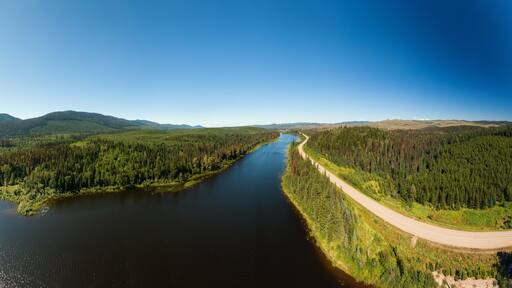 Scenic Panoramic Lake View of Curvy Road in Canadian Nature on a Sunny Summer Day. North of Prince George, John-Hart Highway, British Columbia.