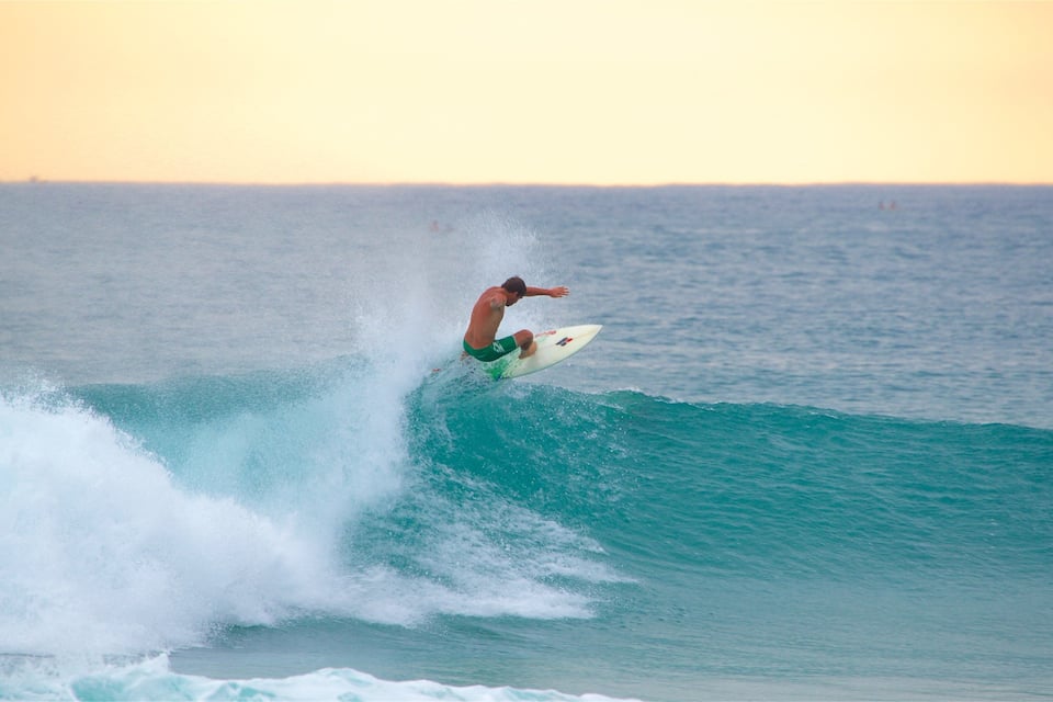 A surfer riding a wave in the ocean.