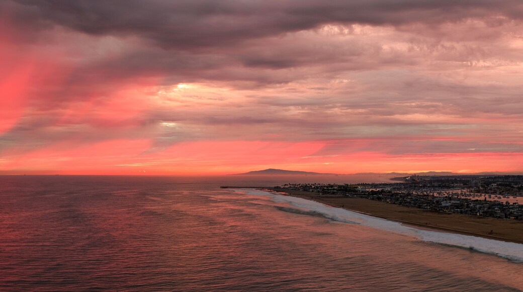 A coastal sunset with a cityscape in the background.