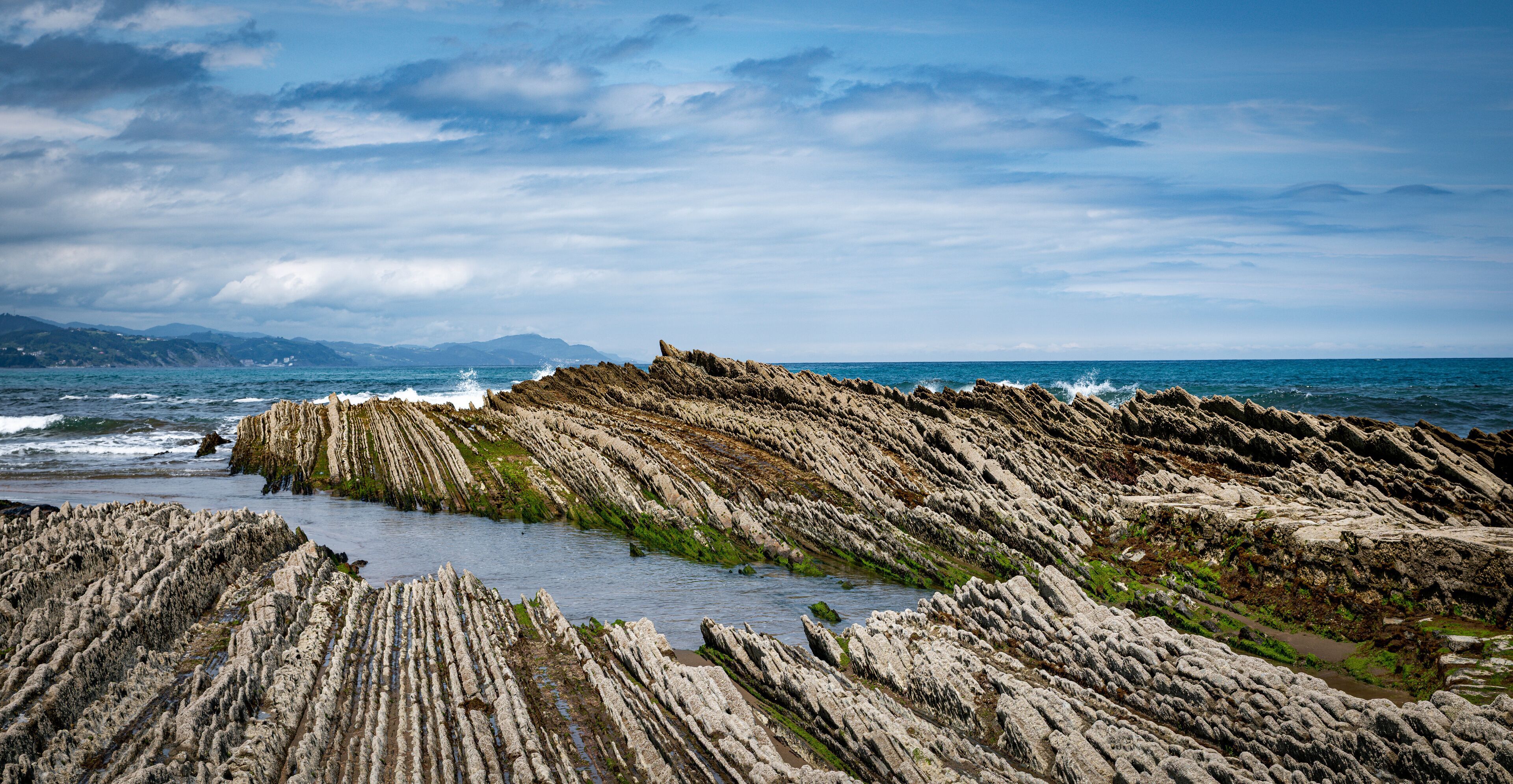 itzurun beach or zumaia beach in spain with blue sky