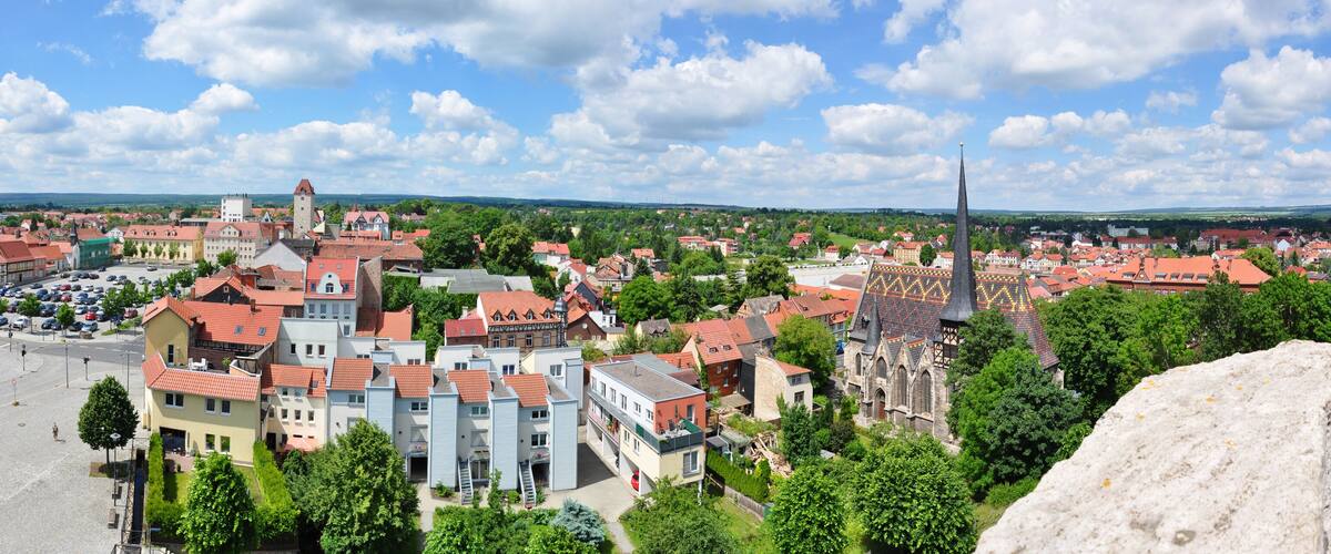 A town with historic buildings, a prominent church, and a large open square.