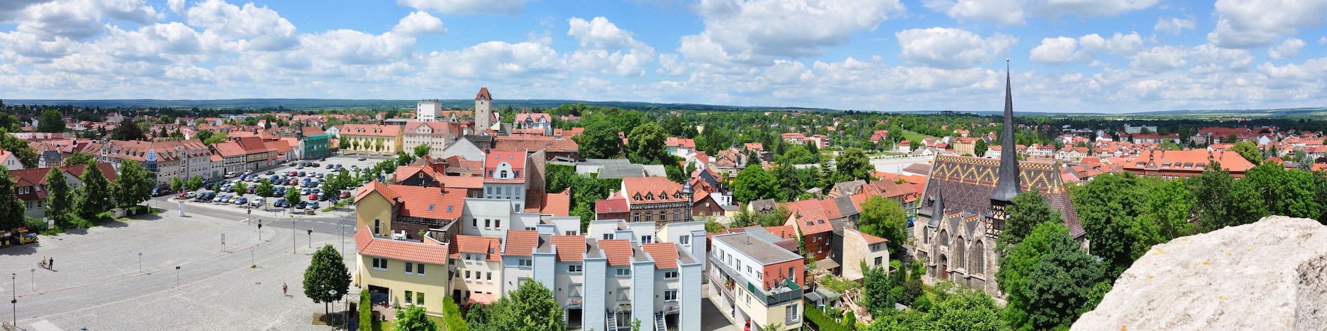 A town with historic buildings, a prominent church, and a large open square.