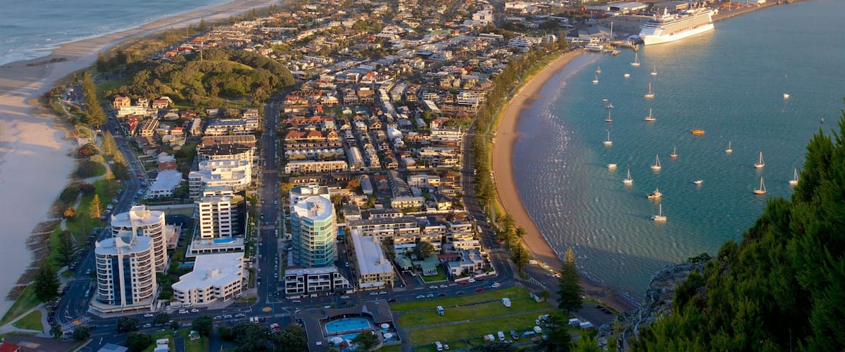 Mount Maunganui showing a coastal town, a bay or harbour and general coastal views