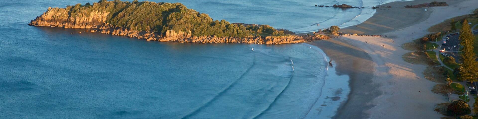 Mount Maunganui showing a sandy beach, rocky coastline and general coastal views