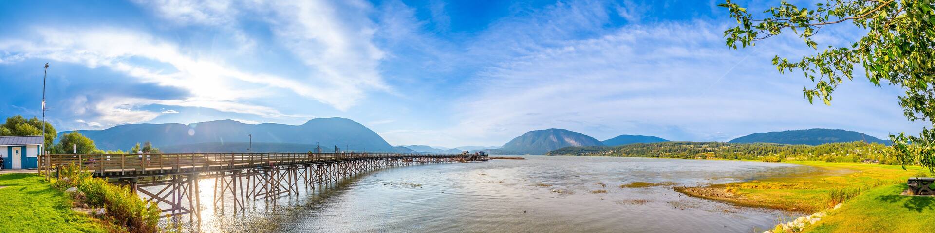 Long wooden pier stretching into shuswap lake in salmon arm, british columbia