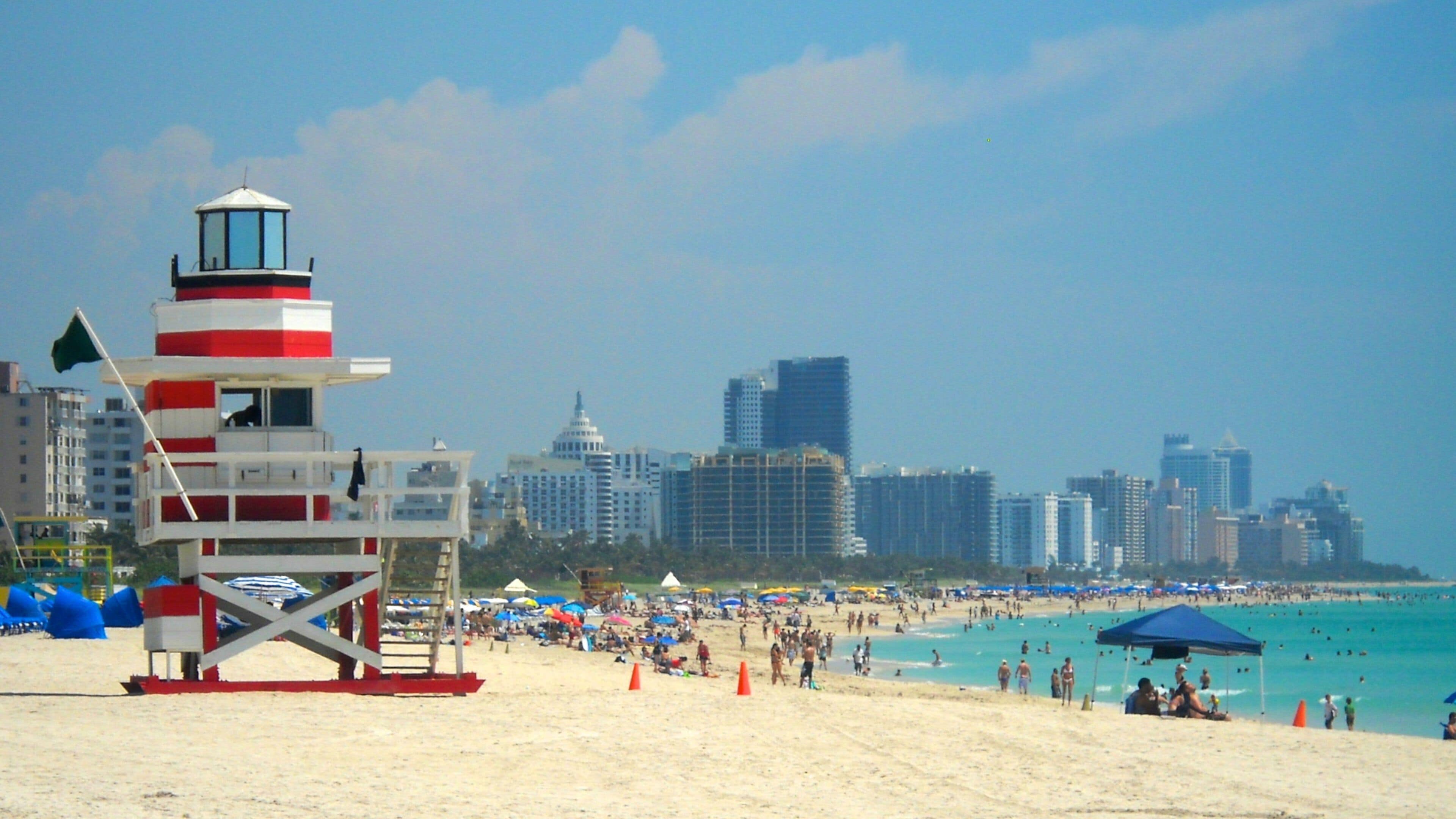Vibrant South Beach skyline with lifeguard tower and sunbathers enjoying a sunny day in Miami Beach, Florida