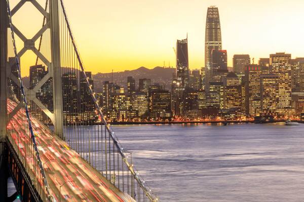 San Francisco Downtown and Bay Bridge in the golden hours. Panoramic view of San Francisco water front from Yerba Buena Island, California, USA.