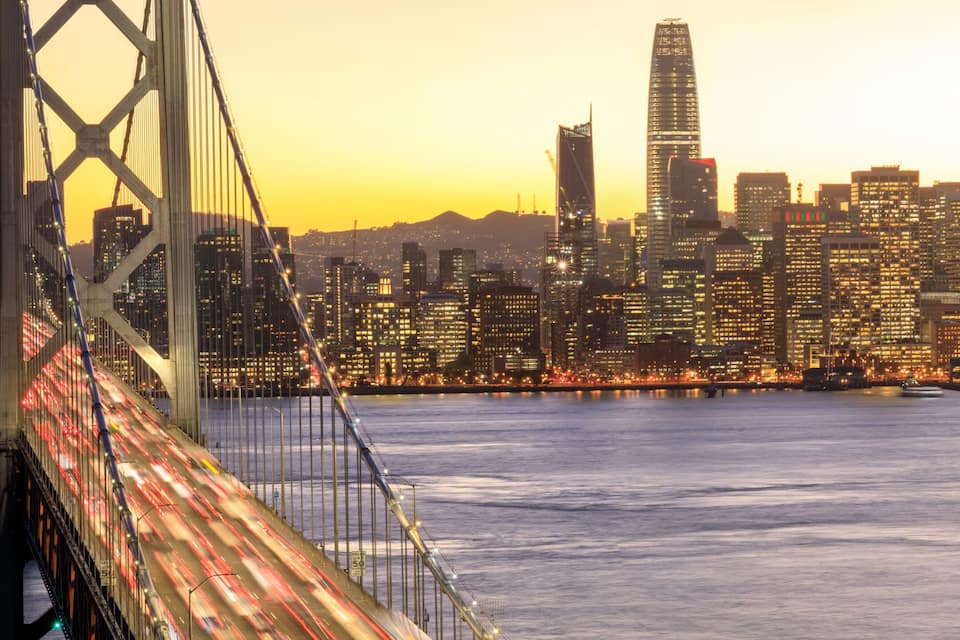 San Francisco Downtown and Bay Bridge in the golden hours. Panoramic view of San Francisco water front from Yerba Buena Island, California, USA.