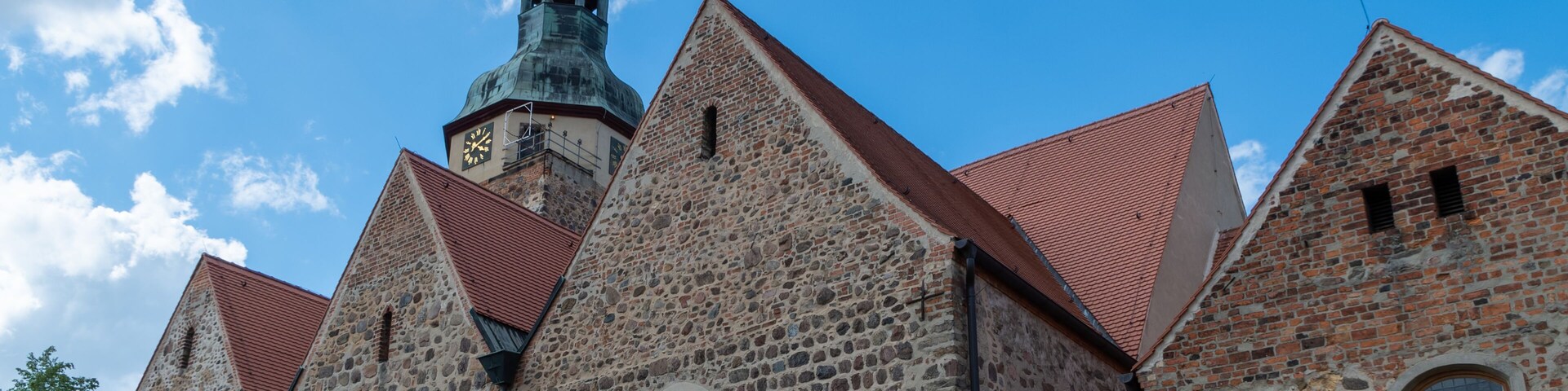 A church with a prominent tower and arched windows.