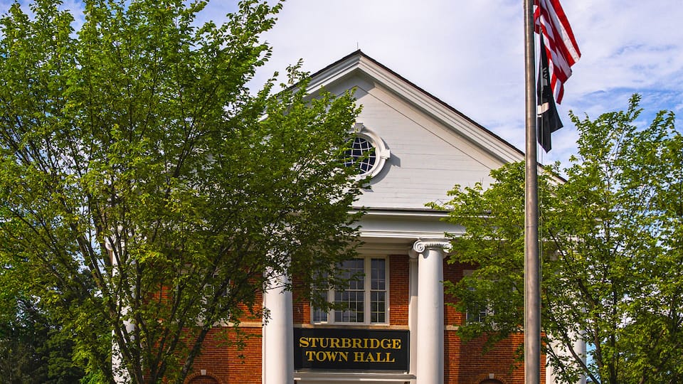 Sturbridge Town Hall in Massachusetts, built in 1838, stands as a proud example of Greek Revival architecture with Colonial Revival enhancements