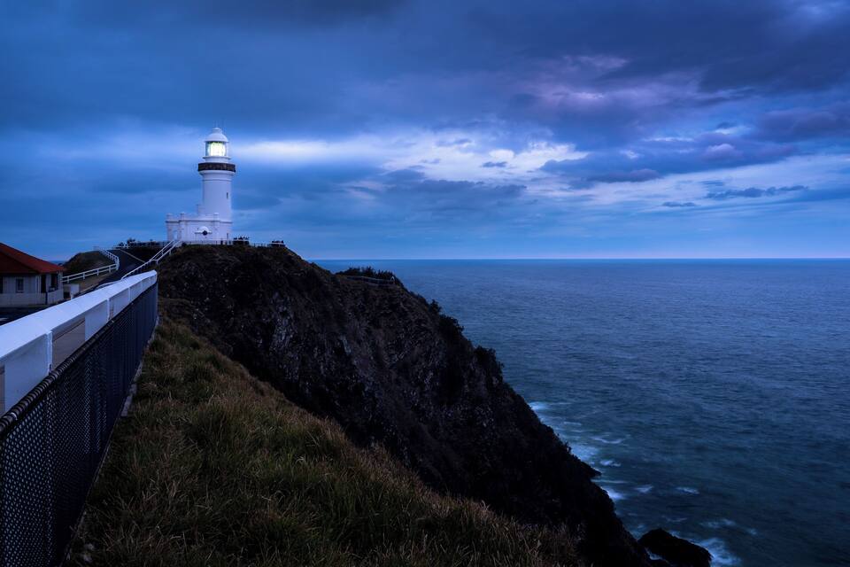 A lighthouse on a cliff overlooking the ocean.