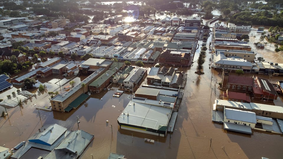 A flooded urban area with buildings and streets submerged in water.