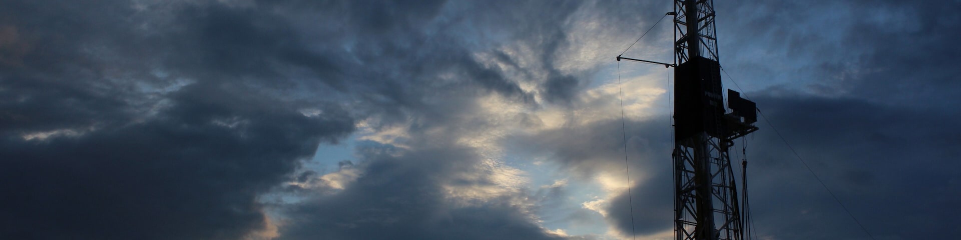 Very nice scenary in West Texas during sunset with an oil rig and clouds in the background