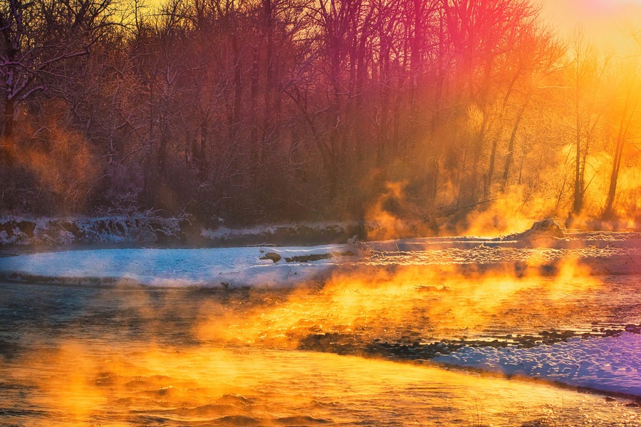 The Gallatin River feeds from Yellowstone National Park south of Bozeman, Montana and runs north to Headwaters State Park where it joins with the Madison and Jefferson to form the Missouri River. This shot was taken on a very cold, early November morning. Winter had landed but thermal vents in the river produce beautiful steam effects through the snow and ice.