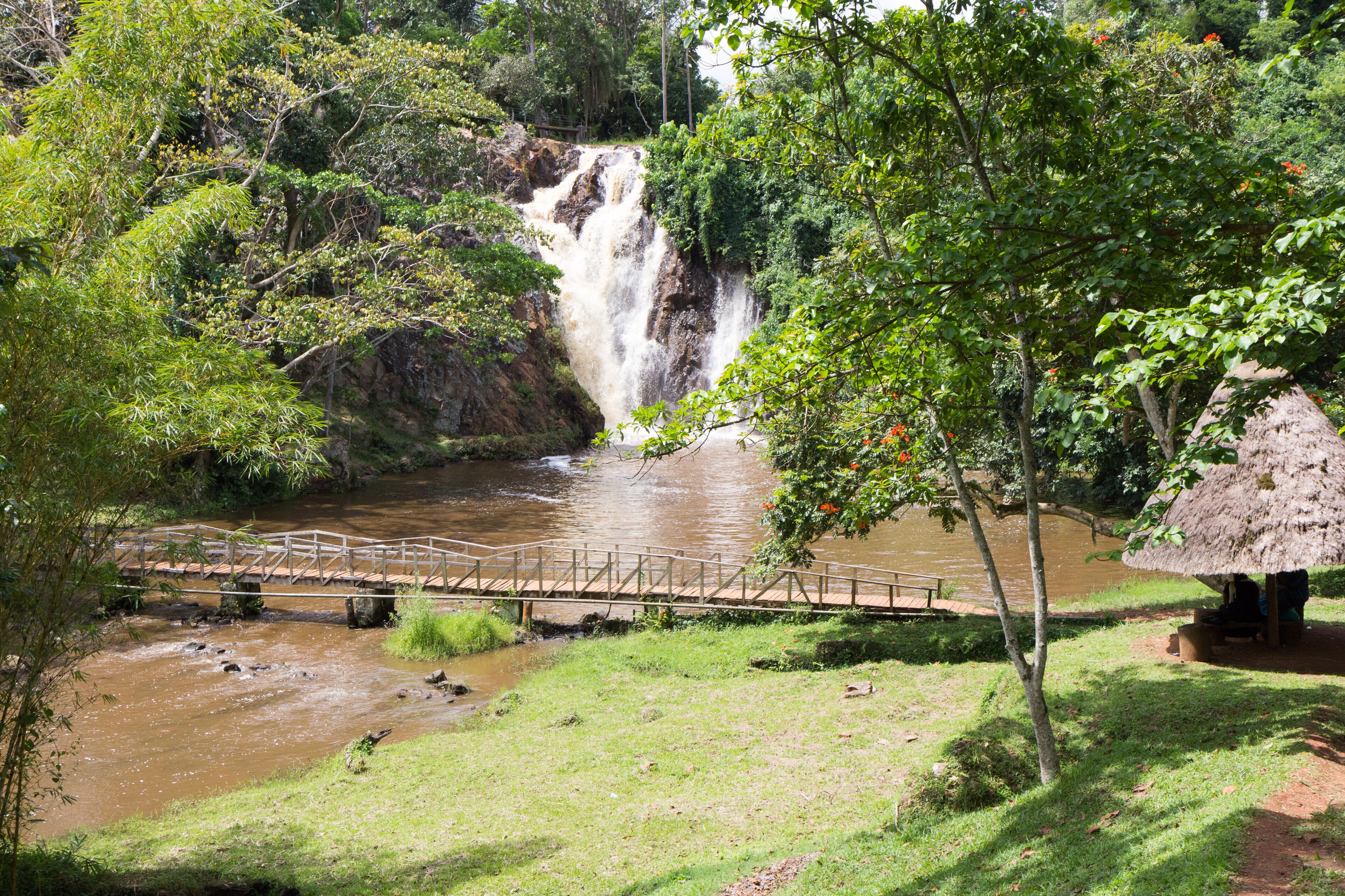 Ssezibwa Falls, Mukono, Uganda. 23 April 2017. A view of the waterfalls and a little pond with a wooden bridge spanning it.