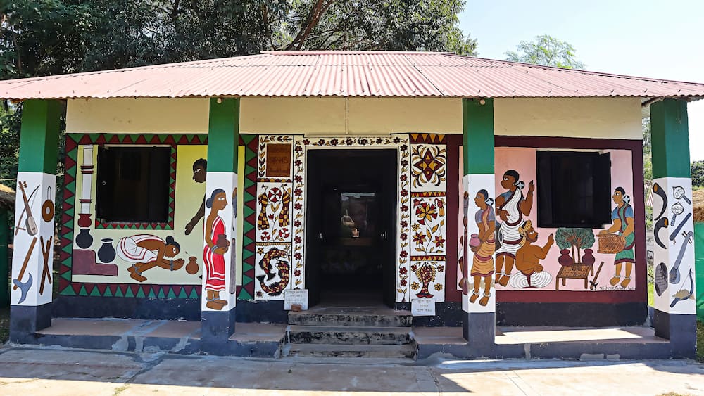 View of a hut displaying traditional tribal equipment and tools in Srijani Shilpagram, Sriniketan, Bolpur, West Bengal, India.