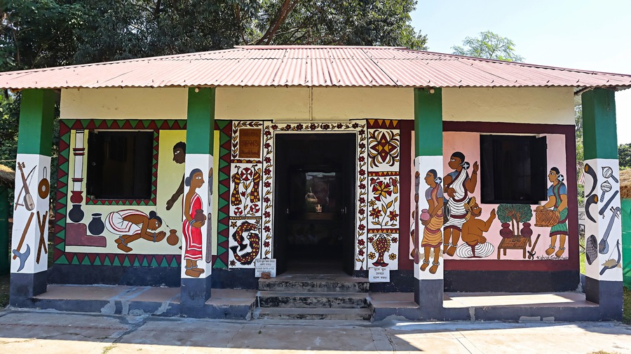 View of a hut displaying traditional tribal equipment and tools in Srijani Shilpagram, Sriniketan, Bolpur, West Bengal, India.