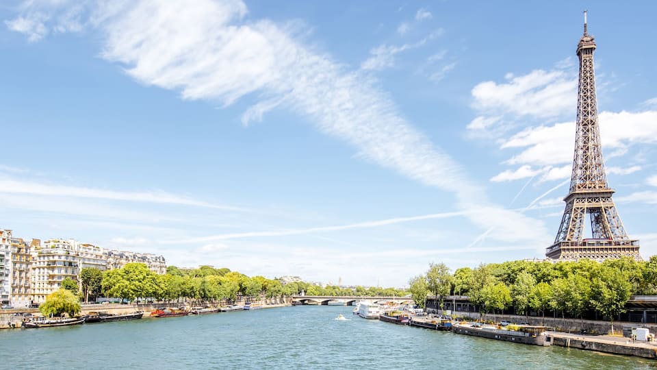 The Eiffel Tower, a river, and surrounding buildings.