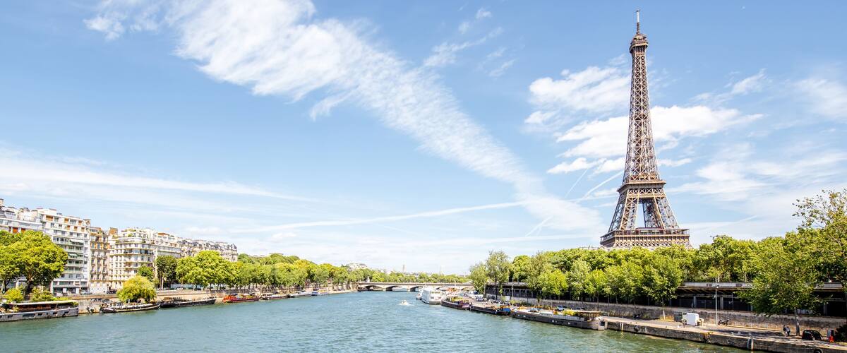 The Eiffel Tower, a river, and surrounding buildings.