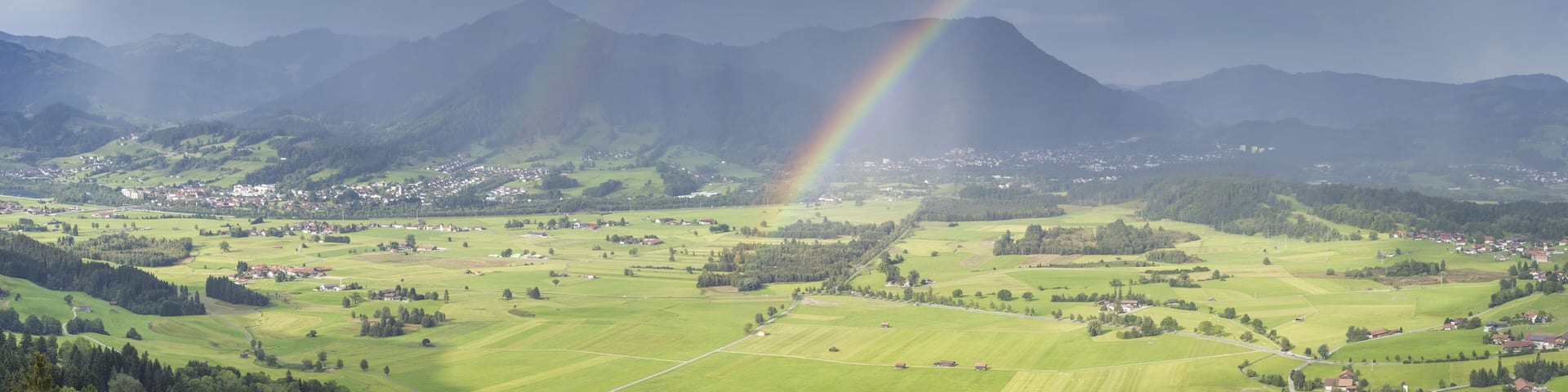 Panorama from Grünten over the Illertal with rainbow to Blaichach and Immenstadt, behind Steineberg, 1660m and Mittagberg, 1451m, Allgäu Alps, Allgäu, Bavaria, Germany