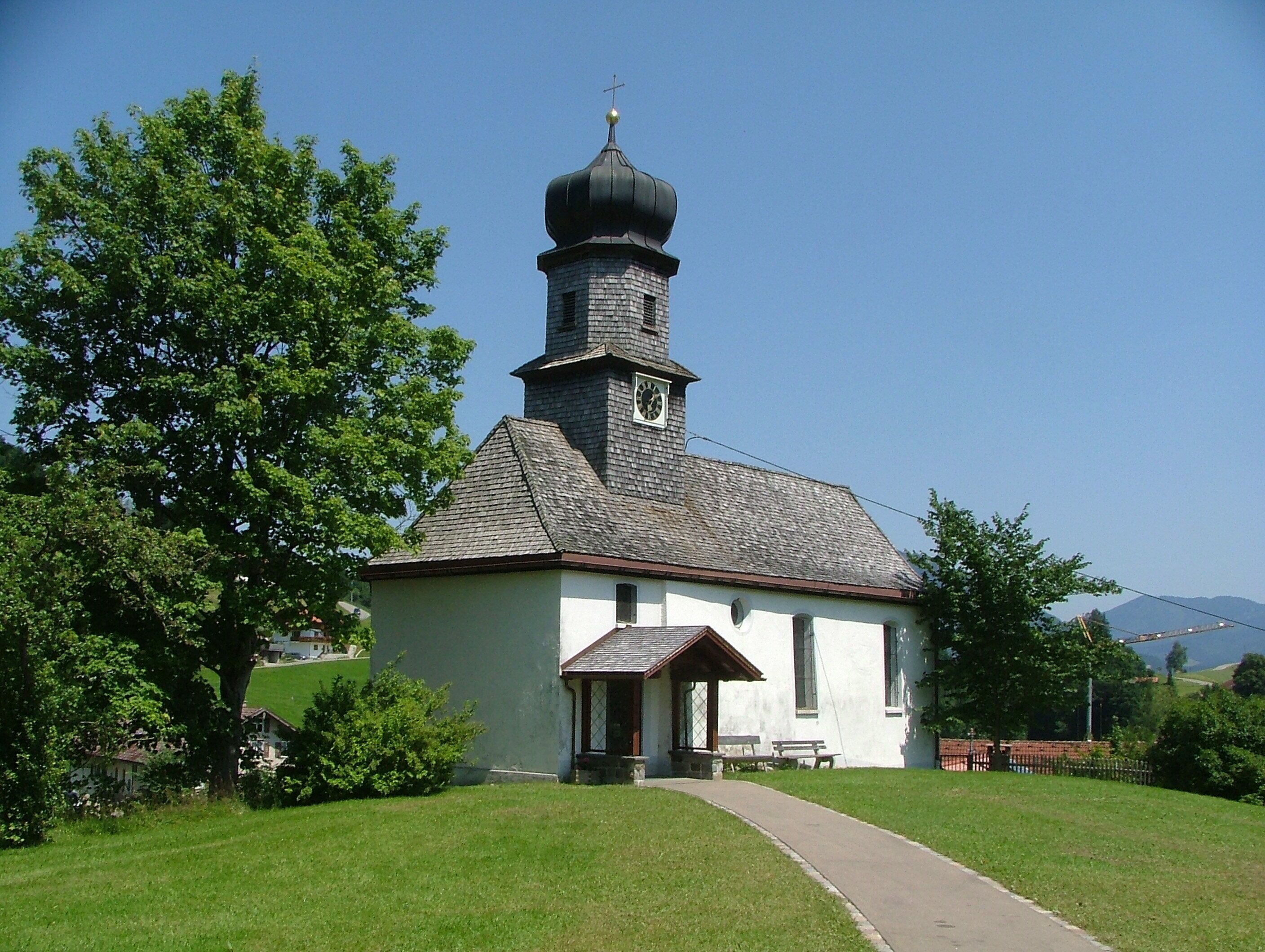 A small church with a bell tower and a clock.