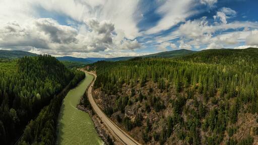 Aerial Panoramic View of a Scenic Highway in the Valley surrounded by Canadian Mountain Landscape. Taken near Clearwater, North of Kamloops, British Columbia, Canada.