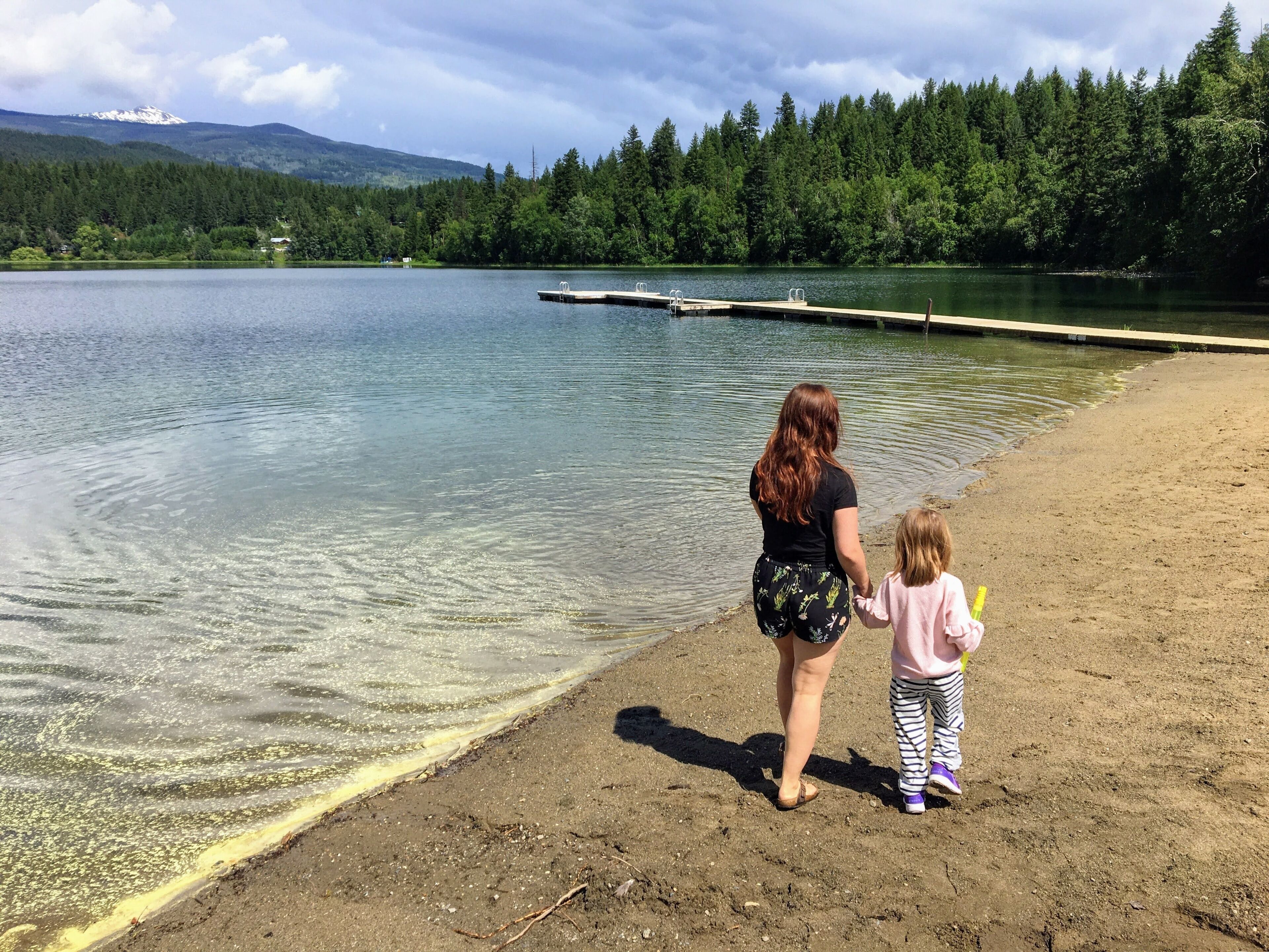 A young mother and her little girl exploring the a lake in Clearwater, British Columbia, Canada