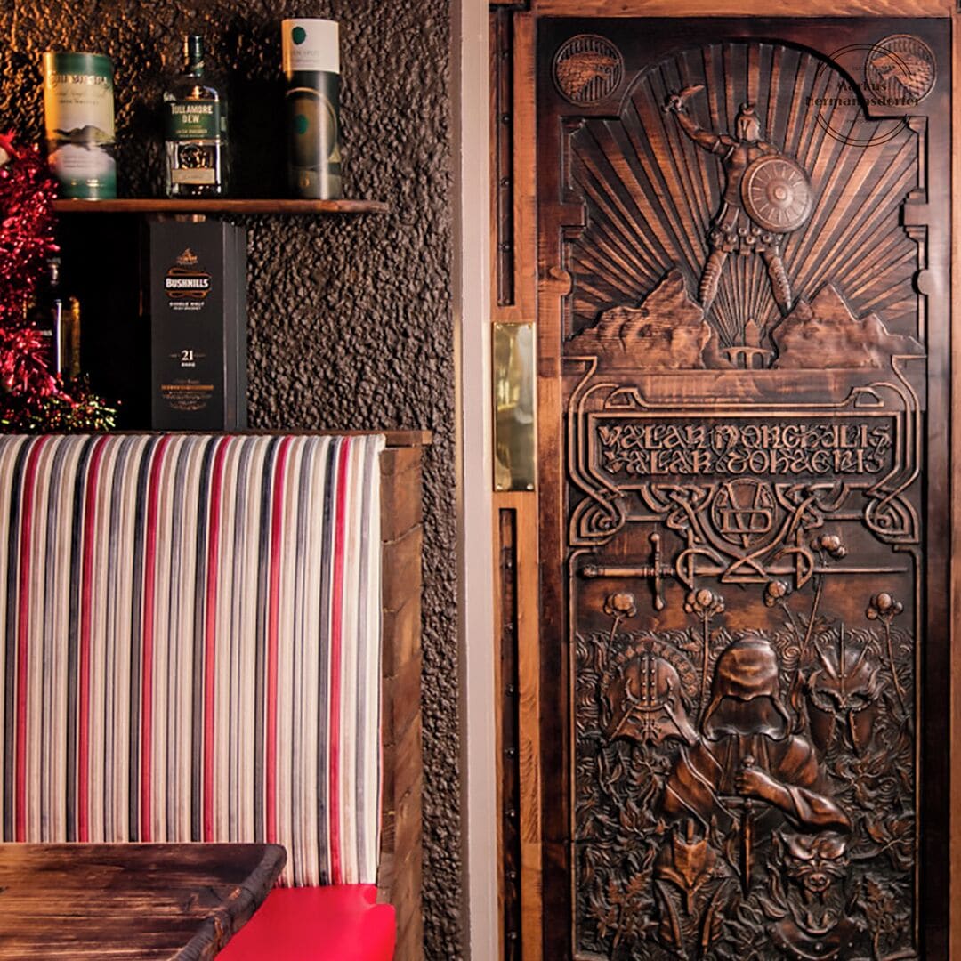 This is a real gem for fans of Game of Thrones: I found this beautiful Door in Mary McBride´s Bar. The Bar was once the smallest pub in Ireland but has now been extended and I can safely say it does a fine pint of Guinness. The Door  sports the infamous Game of Thrones line ‘Valar Morghulis’ or ‘All men must die’ in High Valyrian. It also features the  Titan of Braavos which guards the harbor entrance to the city. Finally it also features some scary looking figures at the bottom. My guess is that these are the slave masters that are currently invading Meereen to get their slaves back whilst Dany has been off burning the leaders of her martial people and giving impressive speeches about freedom and dragons.