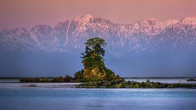 ameharashi coast with a view of the snowy tateyama mountains.