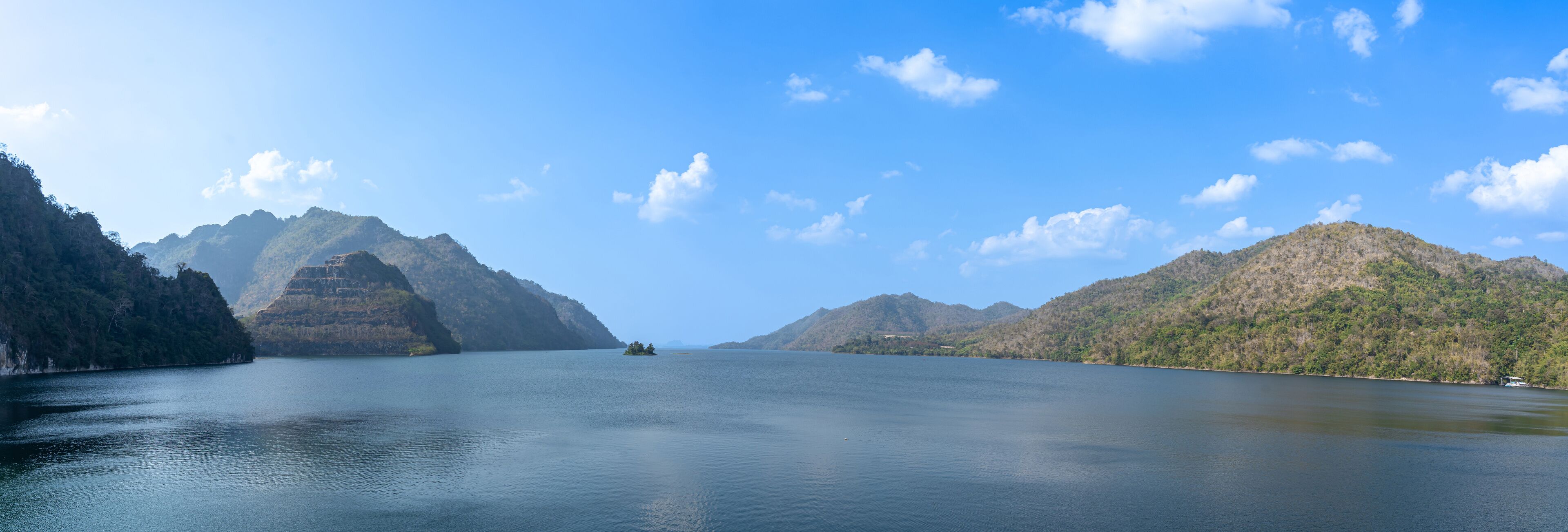 A calm lake surrounded by mountains.