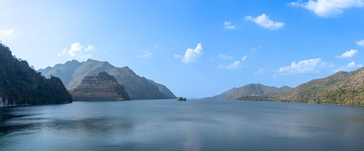 A calm lake surrounded by mountains.