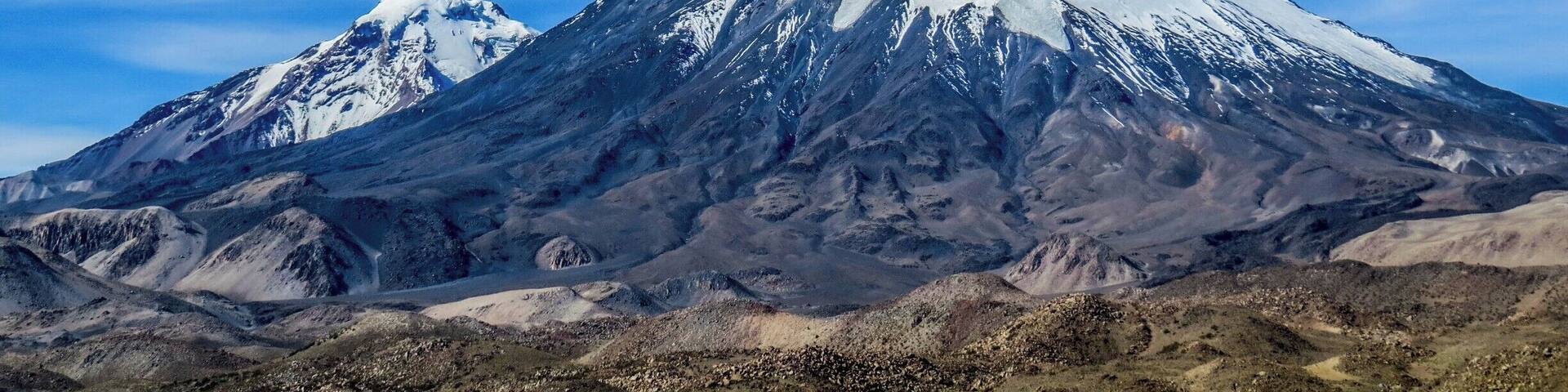 Parinacota and Pomerape volcanoes on the border of Chile and Bolivia. This photo was taken on the chilean side at Lauca National Park.