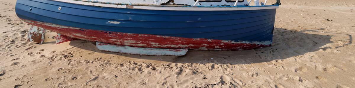 Low tide and old abandoned boat in the Cotentin coast. The havre of Saint-Germain-sur-Ay