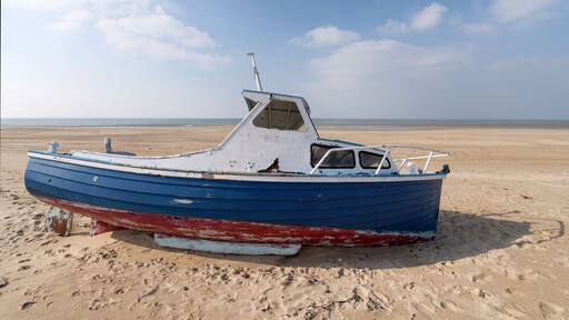 Low tide and old abandoned boat in the Cotentin coast. The havre of Saint-Germain-sur-Ay