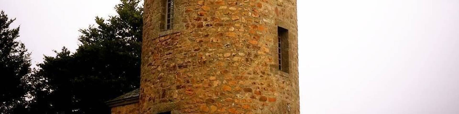 Rapunzel tower of Masseret. Cute village with the tower in the centre and a big hotel next door.