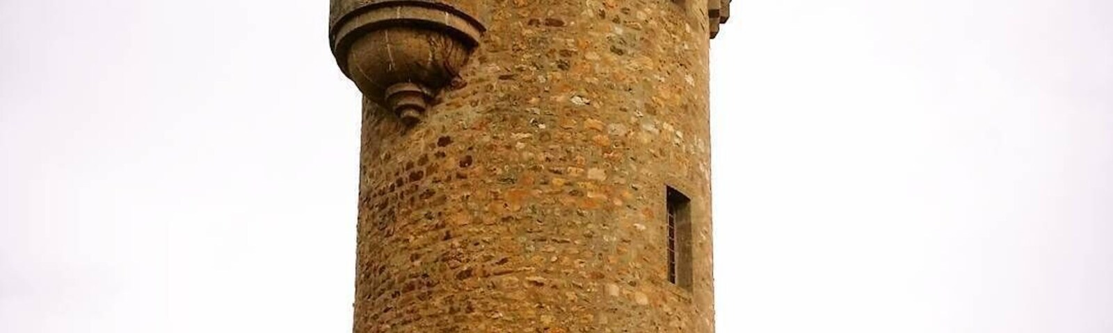 Rapunzel tower of Masseret. Cute village with the tower in the centre and a big hotel next door.