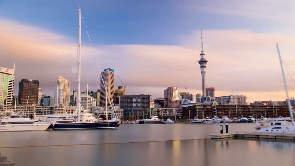 Viaduct Harbour featuring a sunset, a high rise building and a bay or harbor