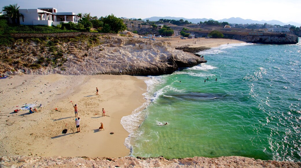 Shatti Al Qurum which includes a sandy beach, general coastal views and rugged coastline