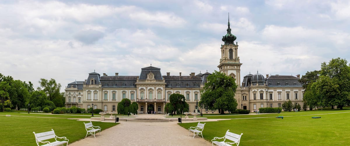 A grand historic building with a prominent tower and symmetrical architecture.
