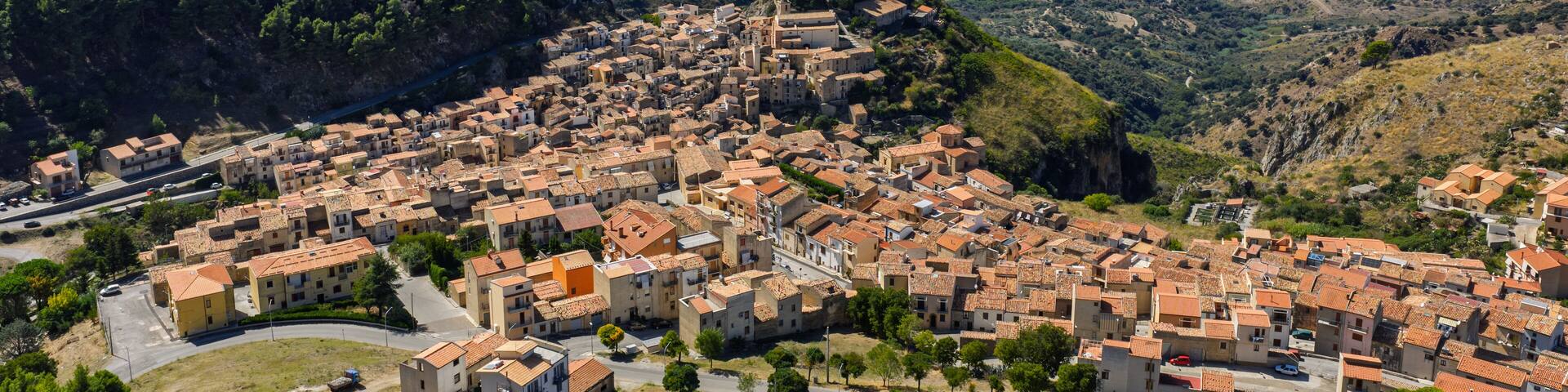 Aerial drone view of Gratteri historic medieval Sicilian mountain village with stone buildings in summer surrounded by Madonie Natural Park forest near Cefalu bay Sicily island southern Italy Europe