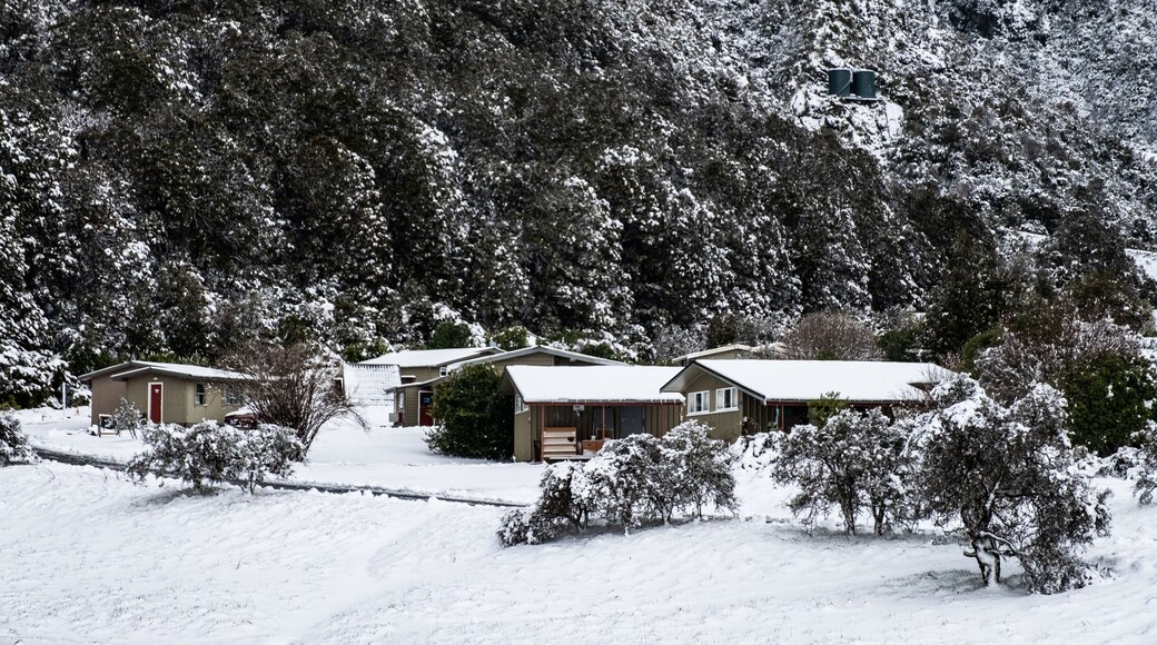 View of the houses in Mount Cook Village covered with white fresh snow in a snowy day.