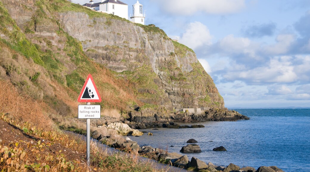 Whitehead/Blackhead lighthouse on cliffs above Belfast Lough. Danger Falling Rocks sign.