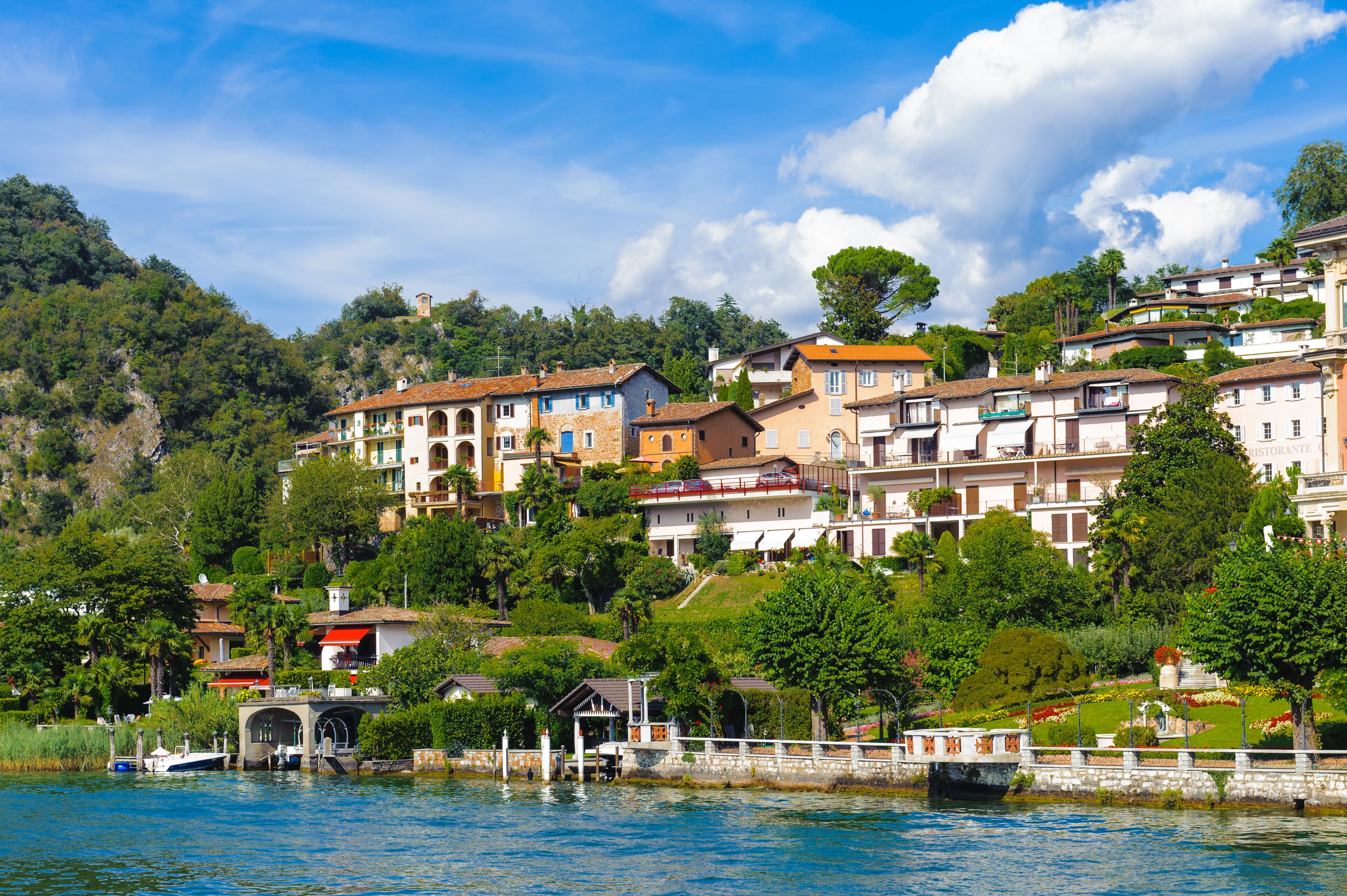 A hillside town with colorful buildings and a bridge over a body of water.