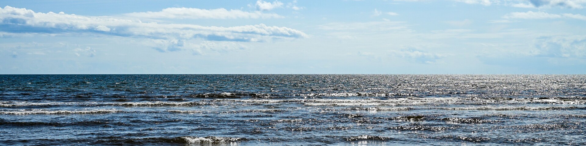 Vacation in Sweden - Vacation on the sandy beach Mossbystrand beach with a view of the Baltic Sea, in summer with a blue sky, Skivarp, Öresund, Skane Lan, Sweden