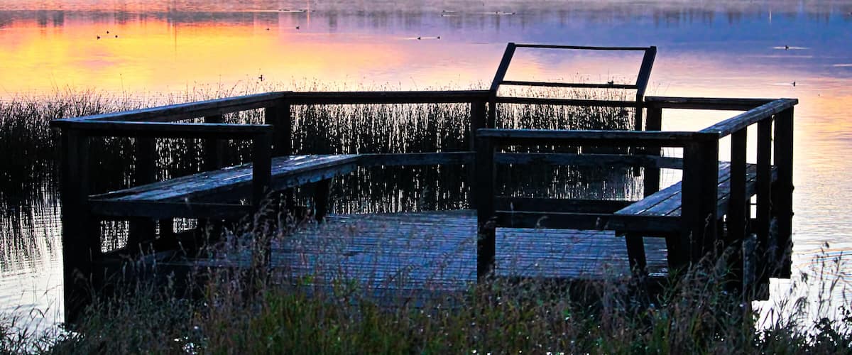 A bird viewing platform at sunrise over Jessie Lake