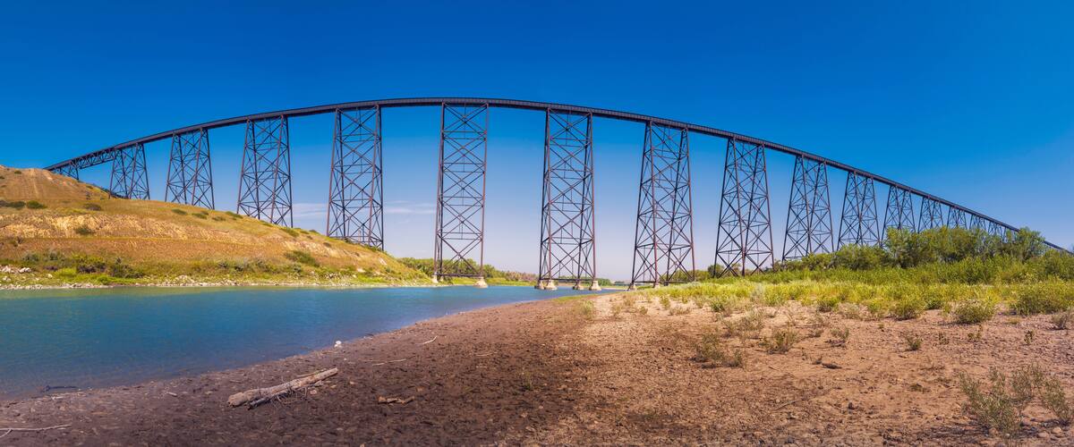 Abstract geometry and shapes of Lethbridge Viaduct Railway Bridge over Old Man River in Lethbridge, Alberta, Canada. Arching effect of wide angle lens.