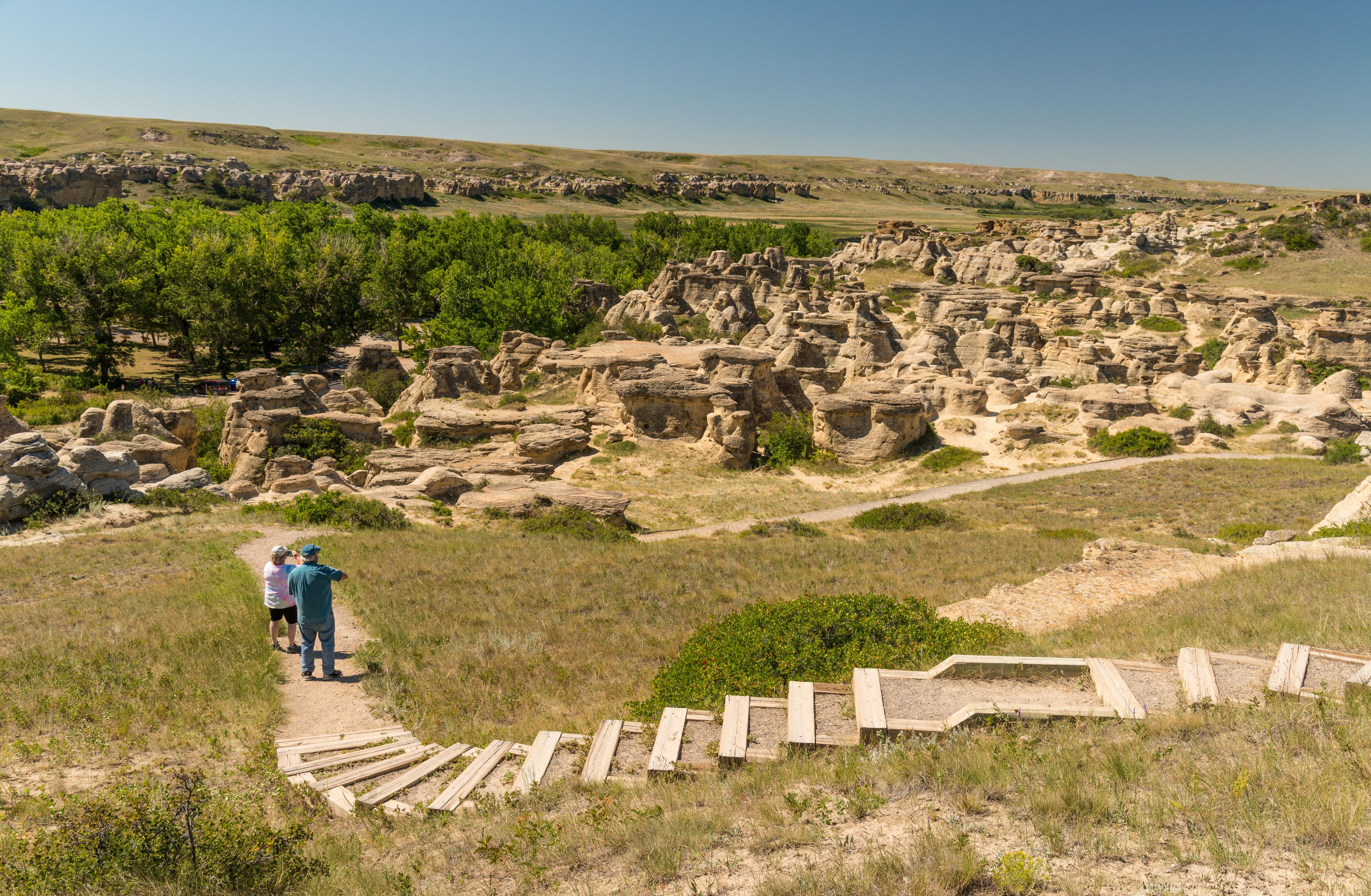 A historical site with ruins and a dirt path.