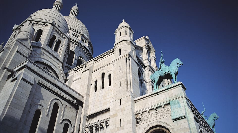 A historic building with domed architecture and statues.